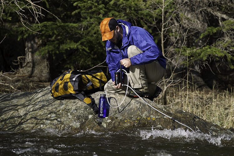 best backpacking water filter in use at the river