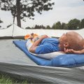 Man on self inflating sleeping pad in a tent