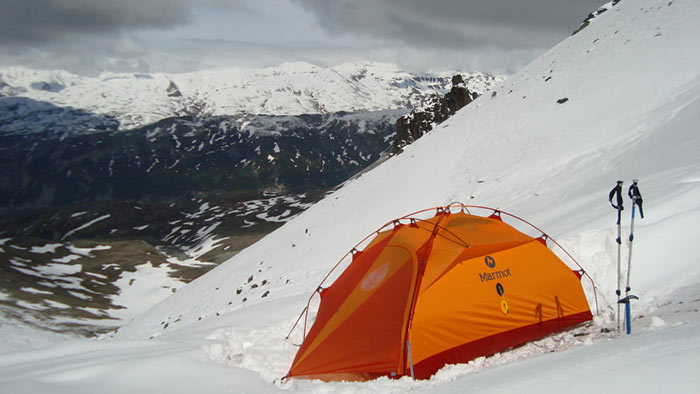 Marmot winter tent on a snow capped hillside