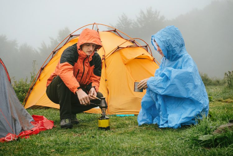 Making coffe while tent camping in the rain