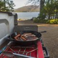Camping stove with sausages cooking