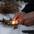 Close up of firelighting with kindling in the snow