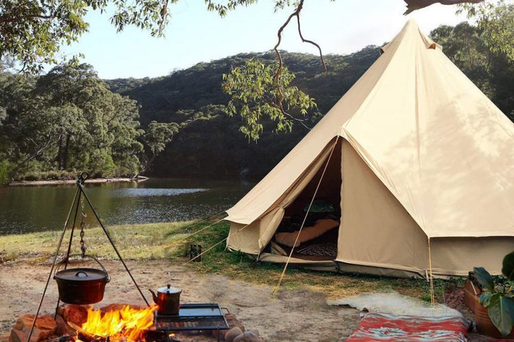 Idyllic canvas bell tent scene by the river